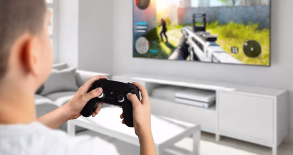 Console Gaming Setup in Living Room Child playing a video game with a wireless controller on a wall-mounted TV in a modern living room